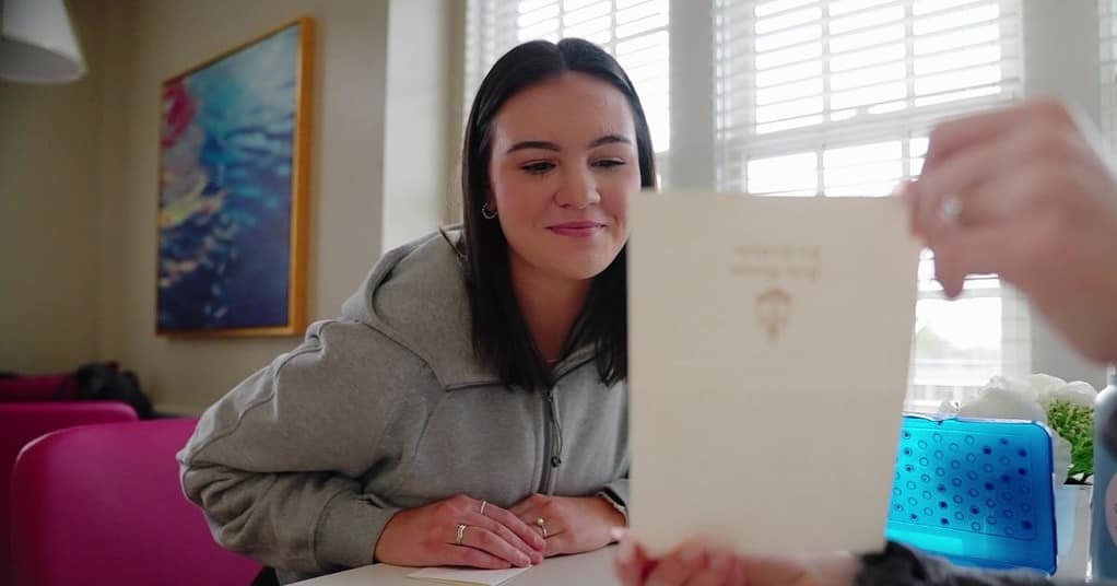 A woman looking at a piece of paper.